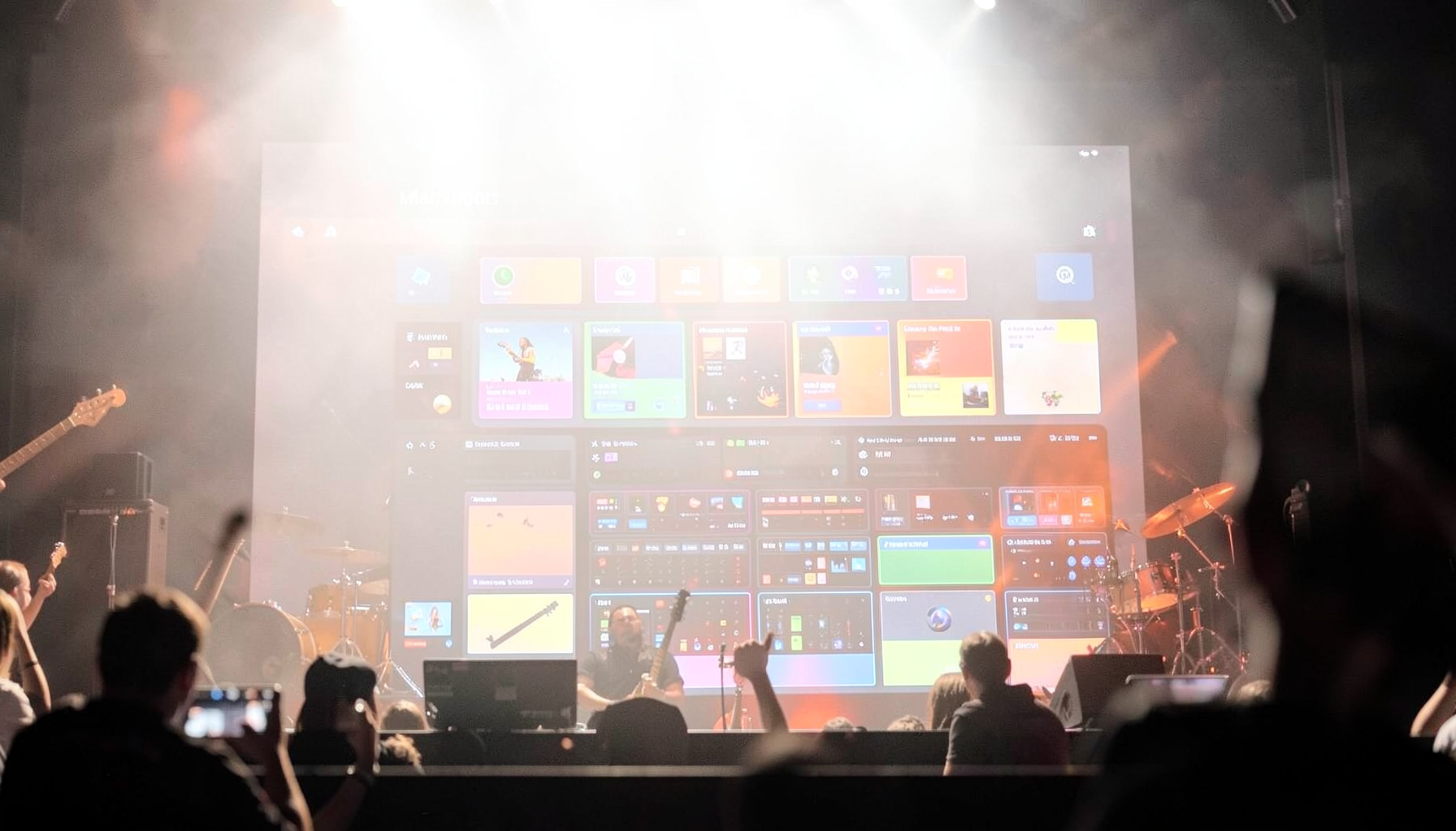 Apple MainStage live performance interface with colorful instrument panels and dark stage lighting ambiance
